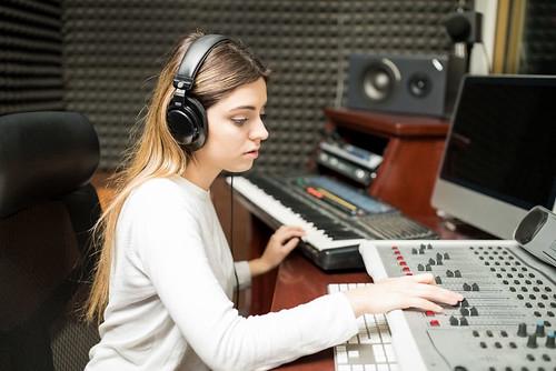 A female sound engineer working in a recording studio
