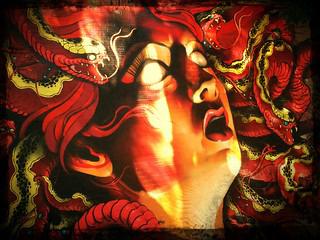 Medusa as a powerful feminist symbol, standing defiantly with her snake hair
