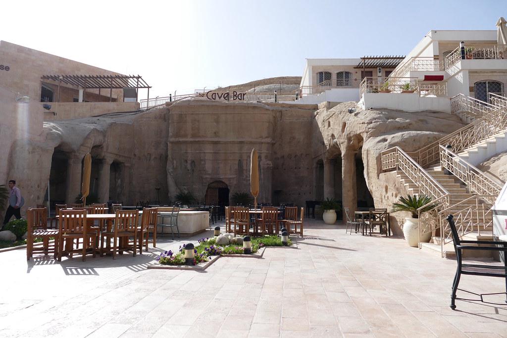 The entrance to The Cave bar, designed to look like an ancient cave opening in a modern desert setting